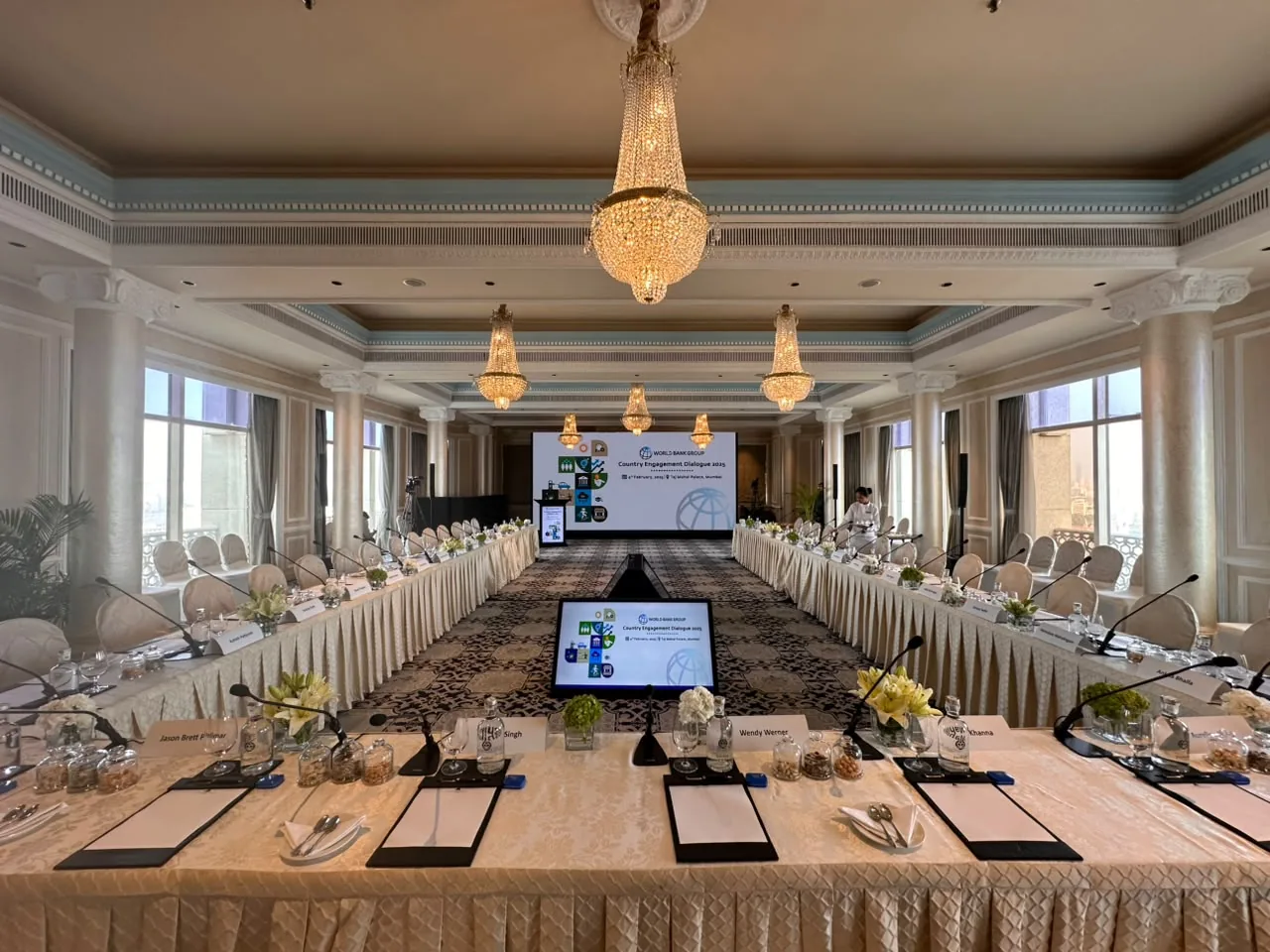 Boardroom AV setup with microphones, confidence display and presentation screen