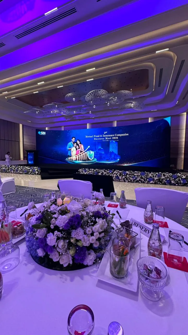 SBI business meet stage with a panoramic LED wall and premium table setting