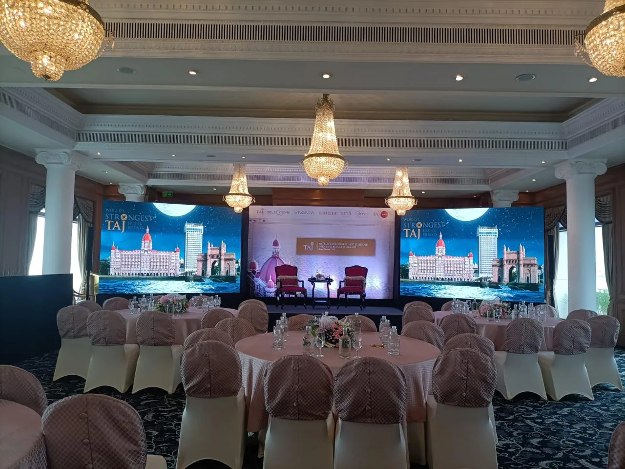 Taj hospitality event stage with two LED displays and audience seating
